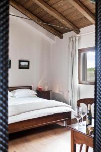a bedroom with a bed and a window and a table at Orsone B&B in Gagliano