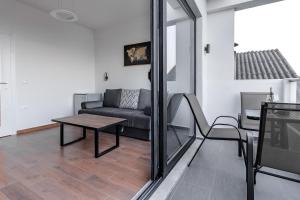 a living room with a couch and a table at CASA BIANCA & Spa 2 in Ulcinj