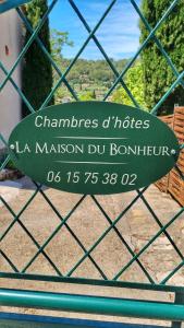 a sign on a fence that reads chambros and nicosiasmama at La maison du bonheur in Cotignac