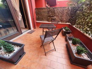 um pátio com uma mesa e vasos de plantas em Sotto l'arco 2 em Sammichele di Bari