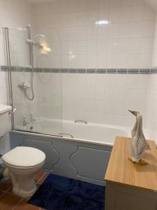 a bathroom with a tub and a toilet and a sink at The Stables, charming converted, 2 bedroom Cottage, Melrose in Darnick