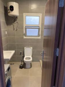 a small bathroom with a toilet and a window at Amwaj Seaside Retreat- Luxury 2BR Chalet in Amwaj Sidi Abdelrahman in El Alamein