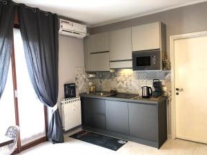 a small kitchen with a sink and a microwave at Studio Flat Policlinico G B Rossi Borgo Roma in Verona