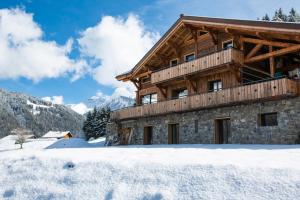 a log cabin in the snow with snow covered at Les Mazots des Fées in Morzine