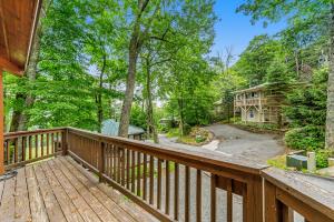 a home with a wooden deck with a driveway at Slopesider 14A in Sugar Mountain