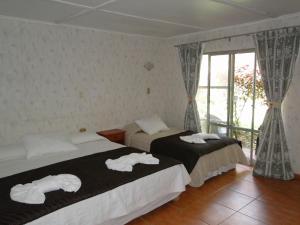 Postel nebo postele na pokoji v ubytování Tupa Hotel