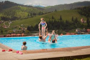 a group of people in a swimming pool at Vysche Neba in Bukovel