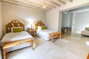 Postel nebo postele na pokoji v ubytování Hotel Casa Canabal by Faranda Boutique