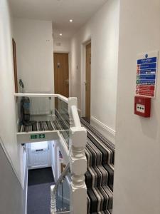 a hospital room with a glass floor and a staircase at The Gladson Guesthouse in Cleethorpes
