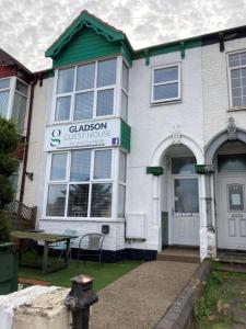 a white building with a table in front of it at The Gladson Guesthouse in Cleethorpes