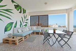 a living room with a couch and a table at Sea,City & Mountain View Apartment in Chania Town