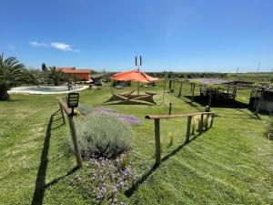 a garden with a fence and flowers in the grass at Casa Daniele in Canino