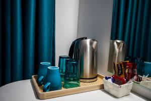 a tray with vases and a coffee maker on a table at Вила Чайка, Villa Chaika in Balchik