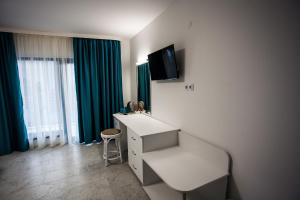 a room with a desk and a tv on the wall at Вила Чайка, Villa Chaika in Balchik