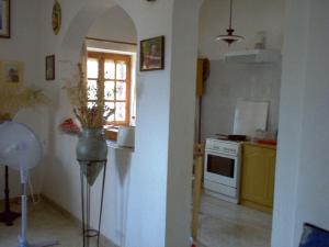 a kitchen with a white stove and a window at Secret Sea Hideaway. in Areopolis