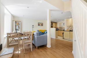a kitchen and living room with a table and a couch at Old Mill Court, Brixham in Brixham
