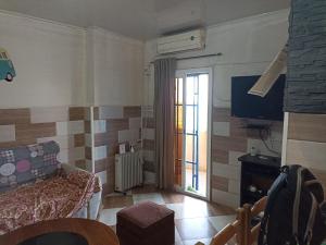 a living room with a couch and a tv at Suite home beldj in Tipaza