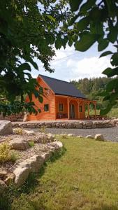 a log cabin with a black roof at Domek nad Czerwienią in Przesieka