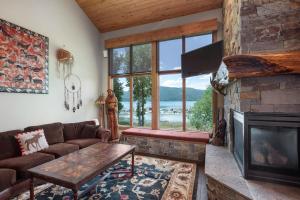 a living room with a couch and a fireplace at Lodge at Whitefish Lake in Whitefish