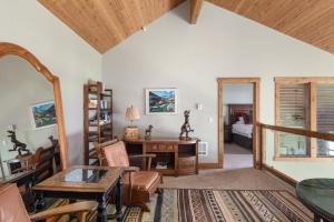 a living room with a table and a desk at Lodge at Whitefish Lake in Whitefish