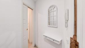 um corredor branco com um lavatório e uma janela em Reposo Sweet Home & Free Parking em Sevilha