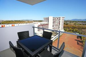 a balcony with a table and chairs on a building at Q Resorts Paddington in Townsville