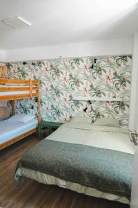 a bedroom with a bed and a floral wallpaper at Cascais Bay Hostel in Cascais