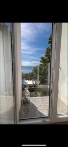 a sliding glass door with a view of a patio at Sea La Vie Rooms in Novi Vinodolski