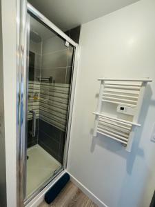 a shower with a glass door in a bathroom at Studio 5 charmant tout équipé à la gare de Lorient in Lorient