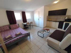a living room with a couch and a table at Dejan Apartments-Top centar-Old town-Low budget Studios in Pula