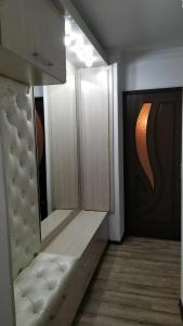 a bathroom with white cabinets and a white bench at Apartment near Farkhadskiy bazar in Tashkent +2 photos