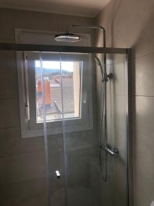 a bathroom with a shower with a window at ApartamentoValleTena9 in Sabiñánigo +24 photos