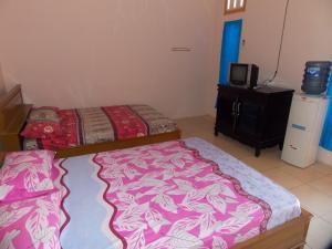 Letto o letti in una camera di Hotel Putra Sindang Asih