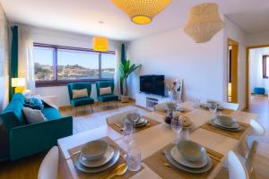 a living room with a table and a dining room at 180º Porto River View in Vila Nova de Gaia