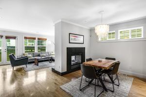 a living room with a fireplace and a table and chairs at Queen Anne Charmer in Seattle