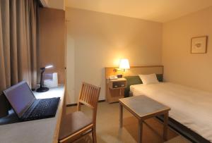 Postel nebo postele na pokoji v ubytování Odakyu Station Hotel Hon-Atsugi