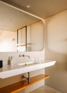 a bathroom with a sink and a mirror at Immerso Hotel, a Member of Design Hotels in Ericeira