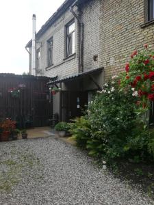 a brick building with a gate and a courtyard at Ventspils Apartments in Ventspils