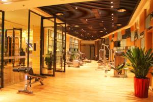 a gym with cardio machines and a potted plant at Lake View Hotel in Beijing