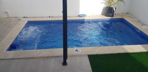 a swimming pool with blue water in a house at Private pool villa with jacuzzi, near beaches in Punta Cana