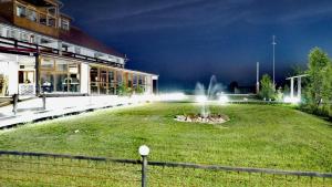 a building with a fountain in the middle of a yard at MARADA felix in Hidişelul-de Sus