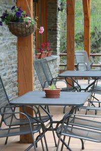 a group of tables with flowers on a patio at Hotel Estanys Blaus in Tavascan +78 photos