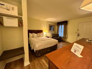 a hotel room with a bed and a desk at Inn at Cemetery Hill in Gettysburg