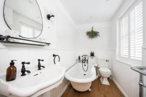a white bathroom with a sink and a toilet at 3 Church Walk in Long Melford in Long Melford