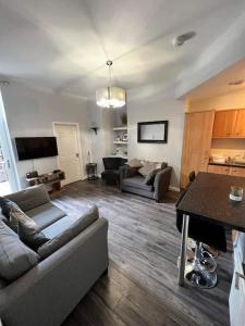 a living room with a couch and a table at Cosy Jesmond 3 bed apartment - fantastic location in Jesmond