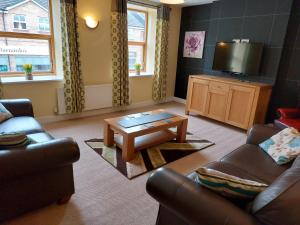 a living room with a couch and a coffee table at Apartment above Sweetharts bakery and coffeeshop in Blackhill, Durham in Shotley Bridge