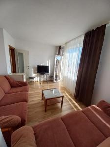 a living room with a couch and a coffee table at Guest House Rona - Free Parking and Sea View in Sveti Vlas