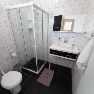 a small bathroom with a toilet and a sink at Casa Colomba in Búzios