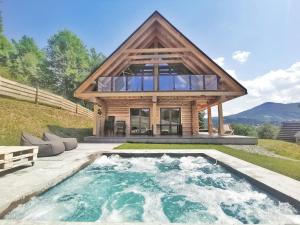 a house with a pool in front of it at Chalet Pine Tree in Zawoja