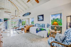 a bedroom with a bed and a living room at Paniolo #202 A & B in Princeville